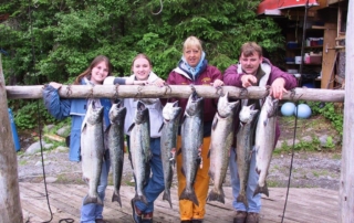 Family posing with salmon