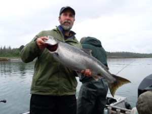 A proud angler displays his salmon bounty.