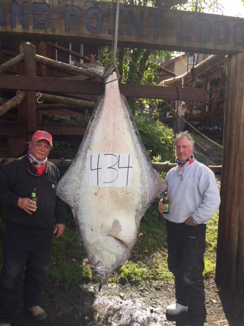 Guest and fishing guide posing with large halibut