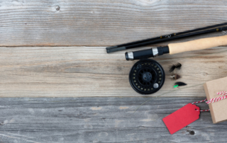 fishing rod, reel and wrapped giftbox with a tag