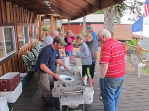 A group of anglers line up for breakfast during their Alaska fishing trip.