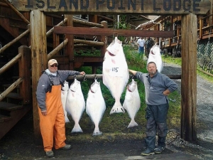 A couple of proud anglers stand next to their bounty during the Alaska fishing season.