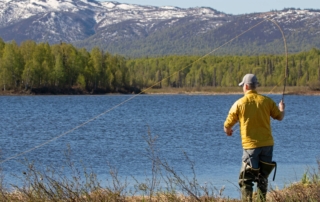 A man fishing. Maybe he is inspired by one of the many fishing movies.