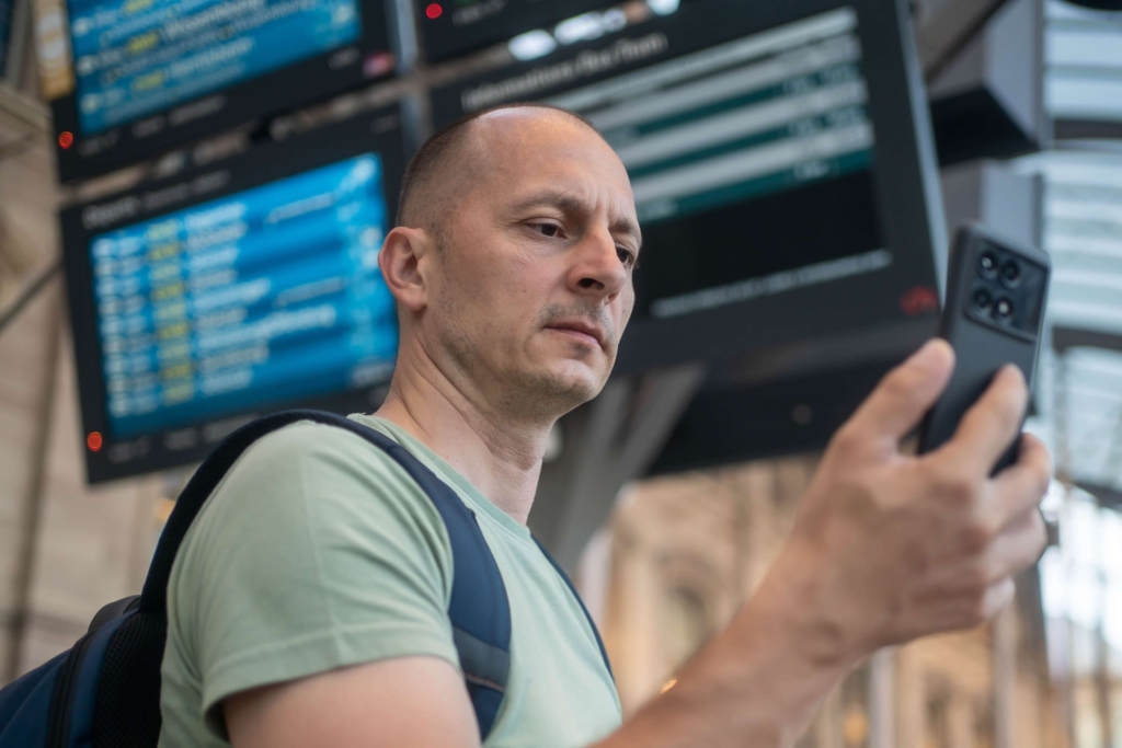 A man reading a Fishing Blog on his phone.